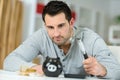 Young man breaking piggy money bank with hammer Royalty Free Stock Photo