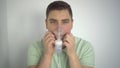 A young man breathes through an inhaler closeup. A man with an oxygen mask is being treated for a respiratory infection.