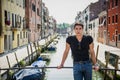 Young Man on Bridge Over Narrow Canal in Venice Royalty Free Stock Photo