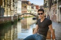 Young Man on Bridge Over Narrow Canal in Venice Royalty Free Stock Photo