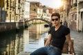Young Man on Bridge Over Narrow Canal in Venice Royalty Free Stock Photo