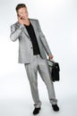 Young man with briefcase and cell phone Royalty Free Stock Photo