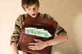 Young man with briefcase full of money Royalty Free Stock Photo