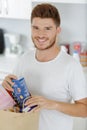 young man bringing groceries home