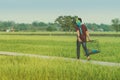 Young man brings two macaw parrots to fly for excercise on the bridge Royalty Free Stock Photo