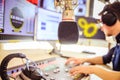 Radio moderator is sitting in a modern broadcasting studio and talking into the microphone Royalty Free Stock Photo