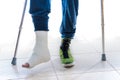 Young man with a broken ankle and a leg cast