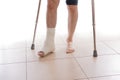 Young man with a broken ankle and a leg cast