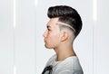 Young man brunette with pompadour volume haircut 50s - 60s. real photo retro hair style for barbershop Royalty Free Stock Photo