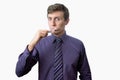 Young man brushing his teeth also looks on at watch on white background Royalty Free Stock Photo