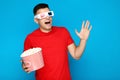 Young man with bucket of popcorn Royalty Free Stock Photo