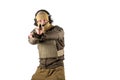 Young man in bulletproof vest aiming into camera with army pistol. He is wearing brown tactical jacket, sandy balaclava, acitve he Royalty Free Stock Photo