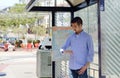 Young man at a bus stop