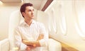 Young man in business class of a plane, toned Royalty Free Stock Photo