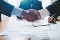 Young man business people shaking hands after brief job for contract signing in modern office with vintage picture style, Royalty Free Stock Photo