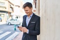 Young man business worker smiling confident using smartphone at street Royalty Free Stock Photo