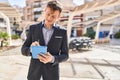 Young man business worker smiling confident using touchpad at park Royalty Free Stock Photo