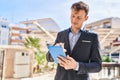 Young man business worker smiling confident using touchpad at park Royalty Free Stock Photo