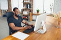 Young man, businessman working in office, looking on computer screen, monitor, with blank white sheet, whiteboard near Royalty Free Stock Photo