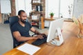 Young man, businessman working in office, looking on computer screen, monitor, with blank white sheet, whiteboard near Royalty Free Stock Photo