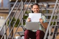 Young man, businessman working outdoors, looking on computer screen, monitor, holding blank white sheet, whiteboard Royalty Free Stock Photo