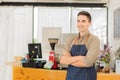 Young man cafe owner standing in front of the shop smiling happily, food and drink concept. Royalty Free Stock Photo