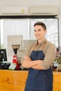 Young man cafe owner standing in front of the shop smiling happily, food and drink concept. Royalty Free Stock Photo