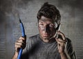 Young man calling for help after accident with dirty burnt face in funny sad expression Royalty Free Stock Photo