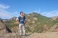 Young man with camera on top of Karadag mountain