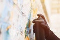 A young man with can spray in hand. Close-up. Royalty Free Stock Photo