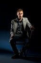 Young man with cane sitting on chair Royalty Free Stock Photo