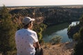 Young man with a cap enjoying the landscape of the Natural Park Hoces del RÃÂ­o DuratÃÂ³n located in Segovia in Spain