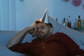 Young man with cap sleeping on sofa after party Royalty Free Stock Photo