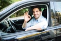 Young man in his car showing okay sign Royalty Free Stock Photo