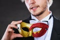 Young man in carnival mask on dark Royalty Free Stock Photo