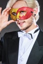 Young man in carnival mask on dark Royalty Free Stock Photo