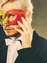 Young man in carnival mask on dark Royalty Free Stock Photo