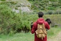 Young man carries his dog in his arms