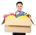 Young man carrying box full of stuff Royalty Free Stock Photo