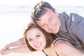 young man carrying his girlfriend on his back at the beach Royalty Free Stock Photo