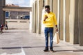 Young man carrying shopping bags and using cell phone Royalty Free Stock Photo