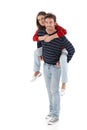 Young man carrying woman pickaback smiling