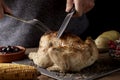 Young man carving a roast turkey Royalty Free Stock Photo