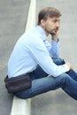 Young man in casual clothes with modern leather weist bag and sm