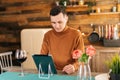 Young man in casual clothes using digital tablet, online communication, internet surfing. Royalty Free Stock Photo