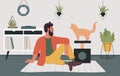 Young man and cat best friend, pet owner hipster sitting on floor playing with kitten