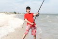 A young man catches a fish Royalty Free Stock Photo