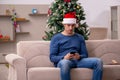 Young man celebrating Christmas alone at home Royalty Free Stock Photo