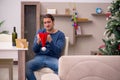 Young man celebrating Christmas alone at home Royalty Free Stock Photo