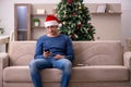 Young man celebrating Christmas alone at home Royalty Free Stock Photo